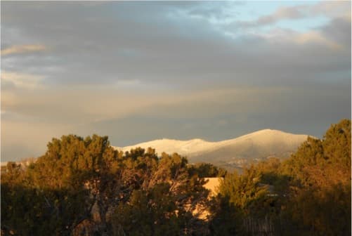 Snow dusting tree-covered hills near Santa Fe