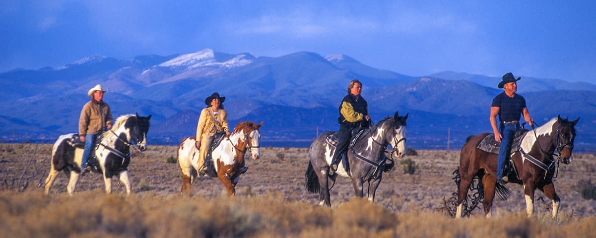 Travelers overlooking Santa Fe at sunset