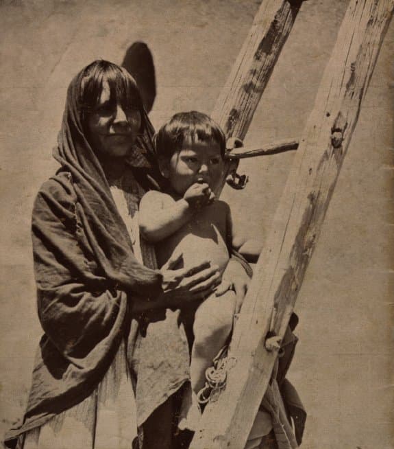 Image of Pueblo woman and child. Harvey Indian Detours brochure.