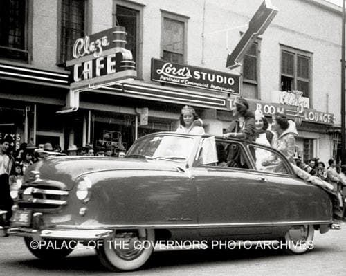 Plaza Cafe as the Fiesta Queen drives by, circa 1957. Courtesy of Palace of the Governors Photo Archives.