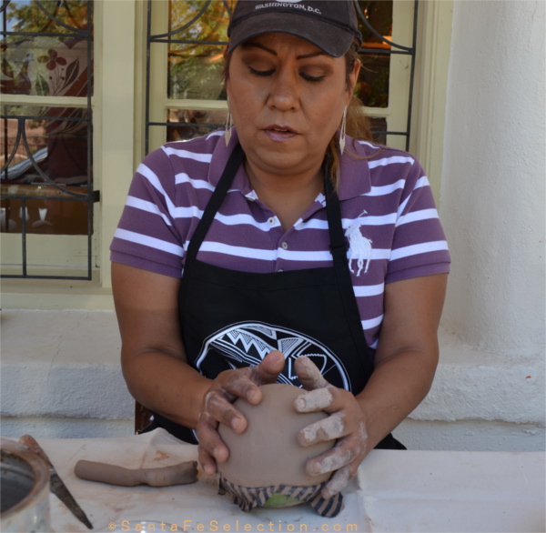 Dominique Toya of Jemez Pueblo demonstrating the creation of a Seed Pot at Lyn A. Fox Gallery, Canyon Road.