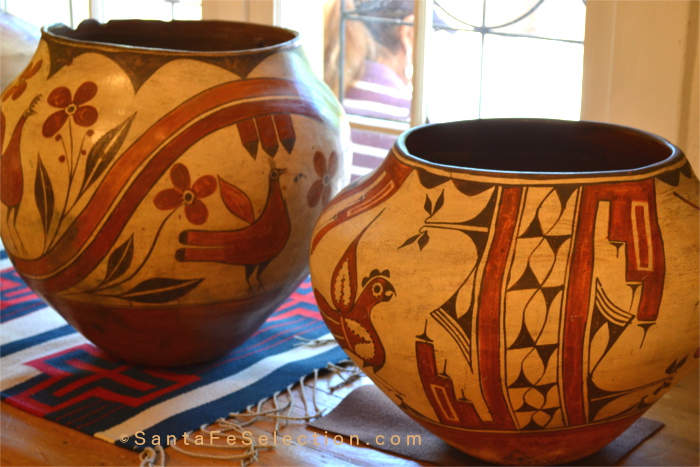 Historic Pots: Zia 4-Color Large Storage Jar with Hide and Putch Native Repair, c. 1900; right. A Large Polychrome Storage Jar with Birds and Rainbow Bands by Seferina Bell, c. 1945